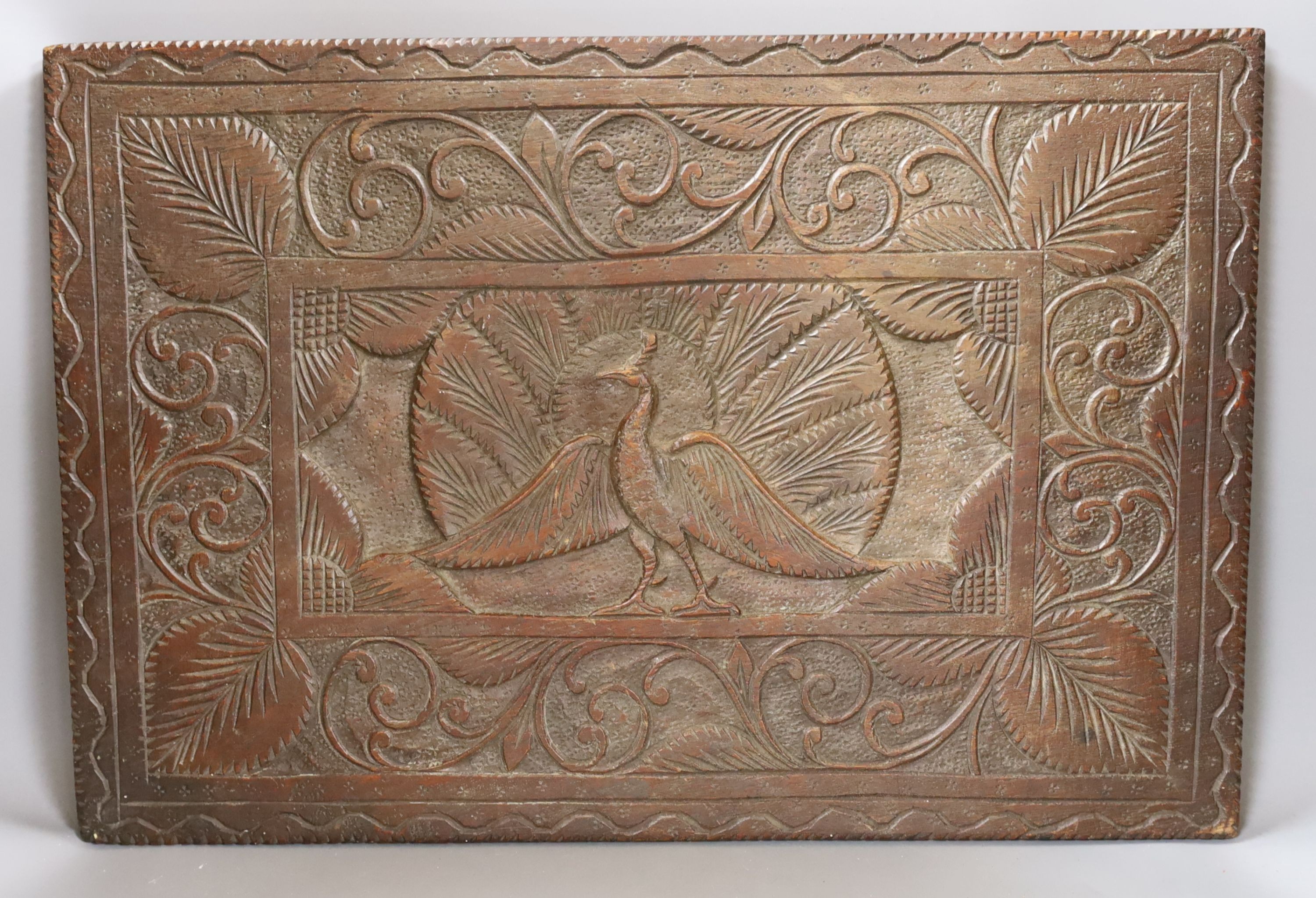 An Indian carved hardwood panel, 51.5 cms high x 35 cms.